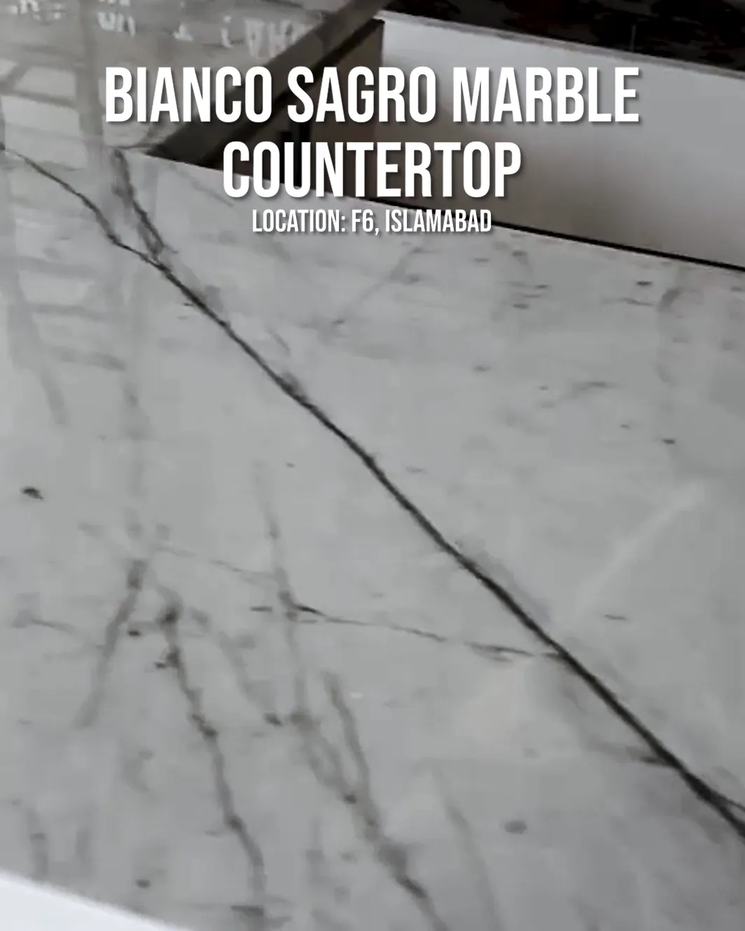 A white marble countertop with grey veins, from a Roots reel